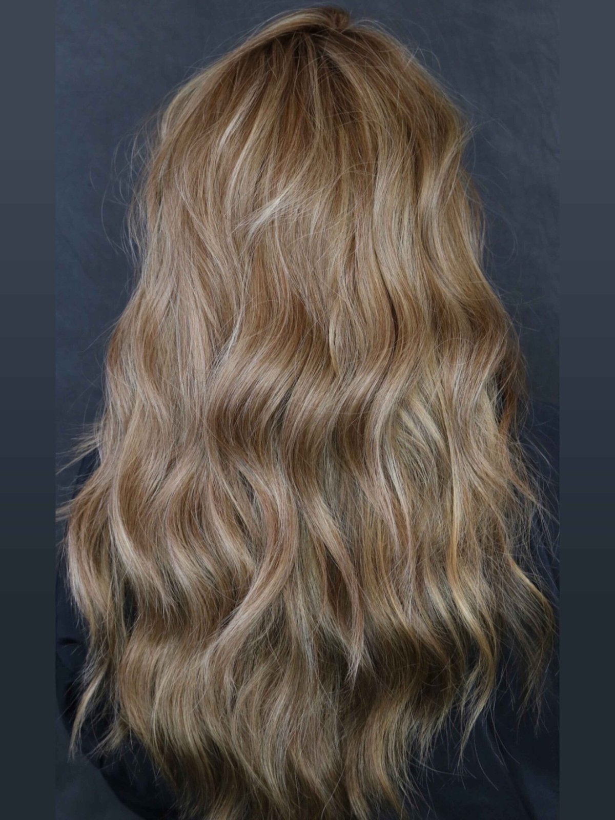 Back view of full, softly waved hair after her Garnish install
