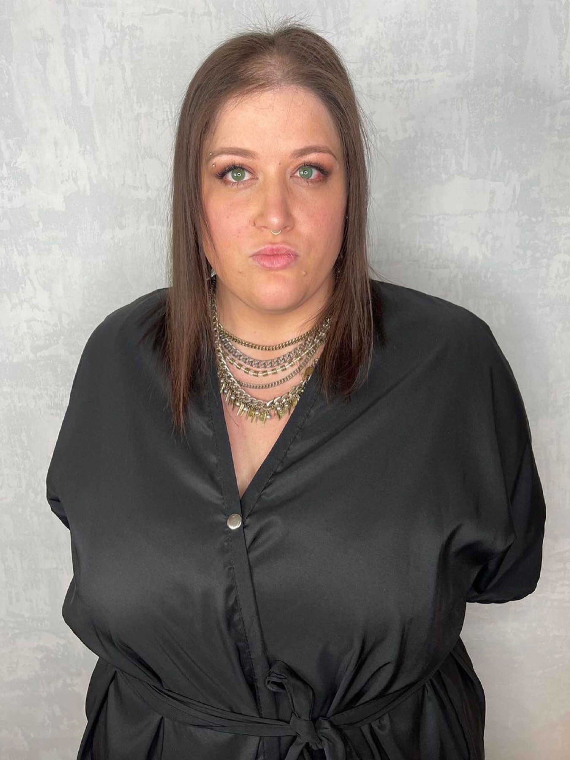 Front view of flat, fine hair with the hairline and part showing through before her Garnish install
