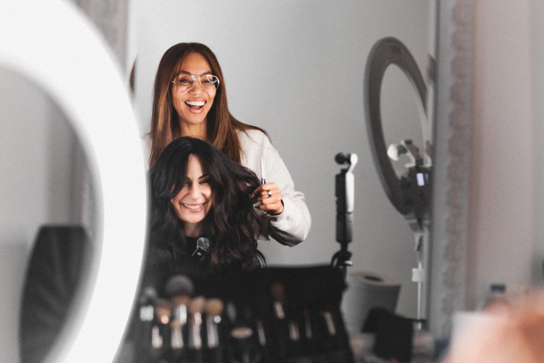 A guest seeing her finished hair in the salon mirror